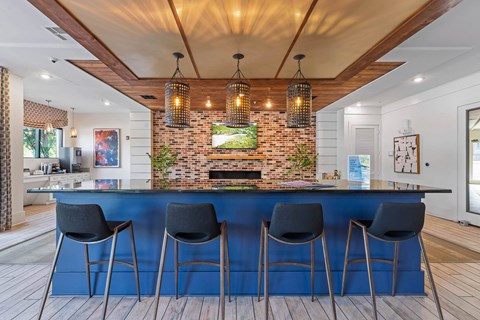 a kitchen with a blue counter top and a brick fireplace